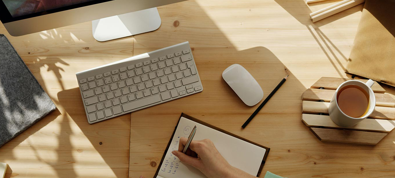 A person working at a tidy, spacious desk while on a video call