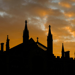 The sun setting behind and silhouetting buildings in Cambridge