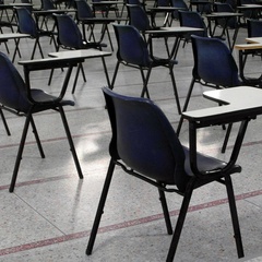 Photo of empty desks in an exam hall