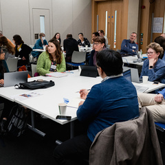 Delegates at a table having a discussion during a workshop