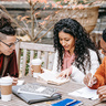 Three students studying together on a picnic bench