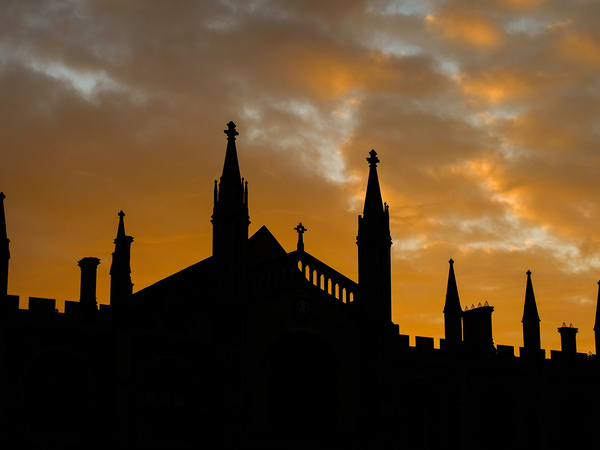 The sun setting behind and silhouetting buildings in Cambridge