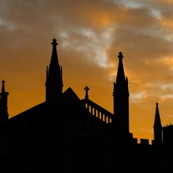 The sun setting behind and silhouetting buildings in Cambridge