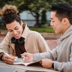 Two students exchanging feedback on work