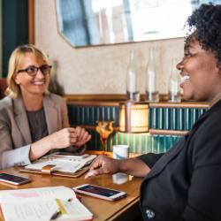 Three women having a discussion over coffee