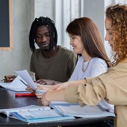 Students gathered round a table for a supervision