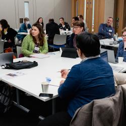 Delegates at a table having a discussion during a workshop