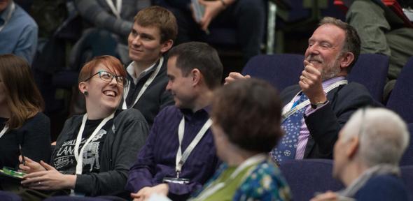 Audience members sharing a joke during the annual Cambridge Teaching Forum