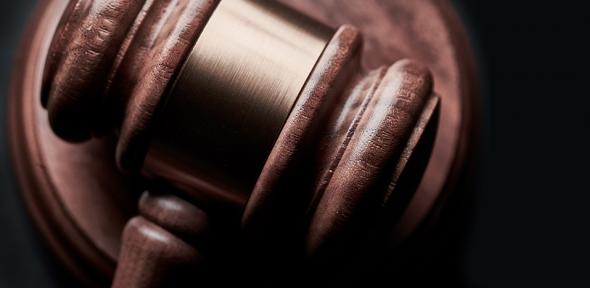 A judge's gavel resting on the bench
