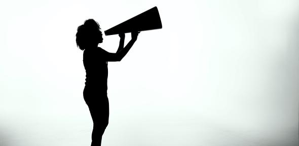 Person holding up a large megaphone