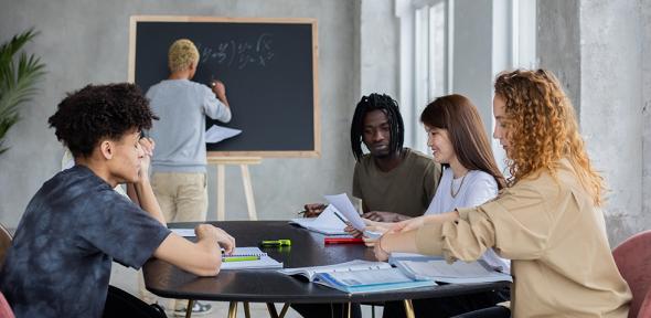 Students gathered round a table for a supervision