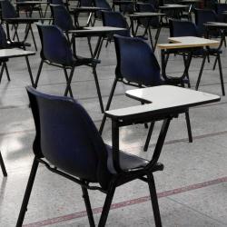 Photo of empty desks in an exam hall