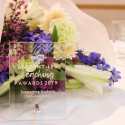 Glass award and flowers from the 2019 Students Union Student-Led Teaching Awards