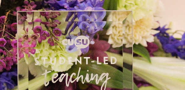 Glass award and flowers from the 2019 Students Union Student-Led Teaching Awards
